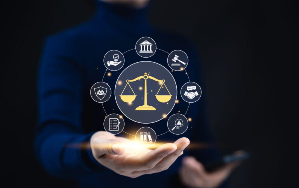 business legislation concept. the scales of justice ensure fair legal law. justice scale surrounded by legal icons, representing law, justice, and business ethics, displayed on an outstretched hand.